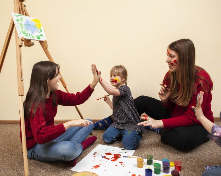 girl-with-down-syndrome-high-fiving-while-painting