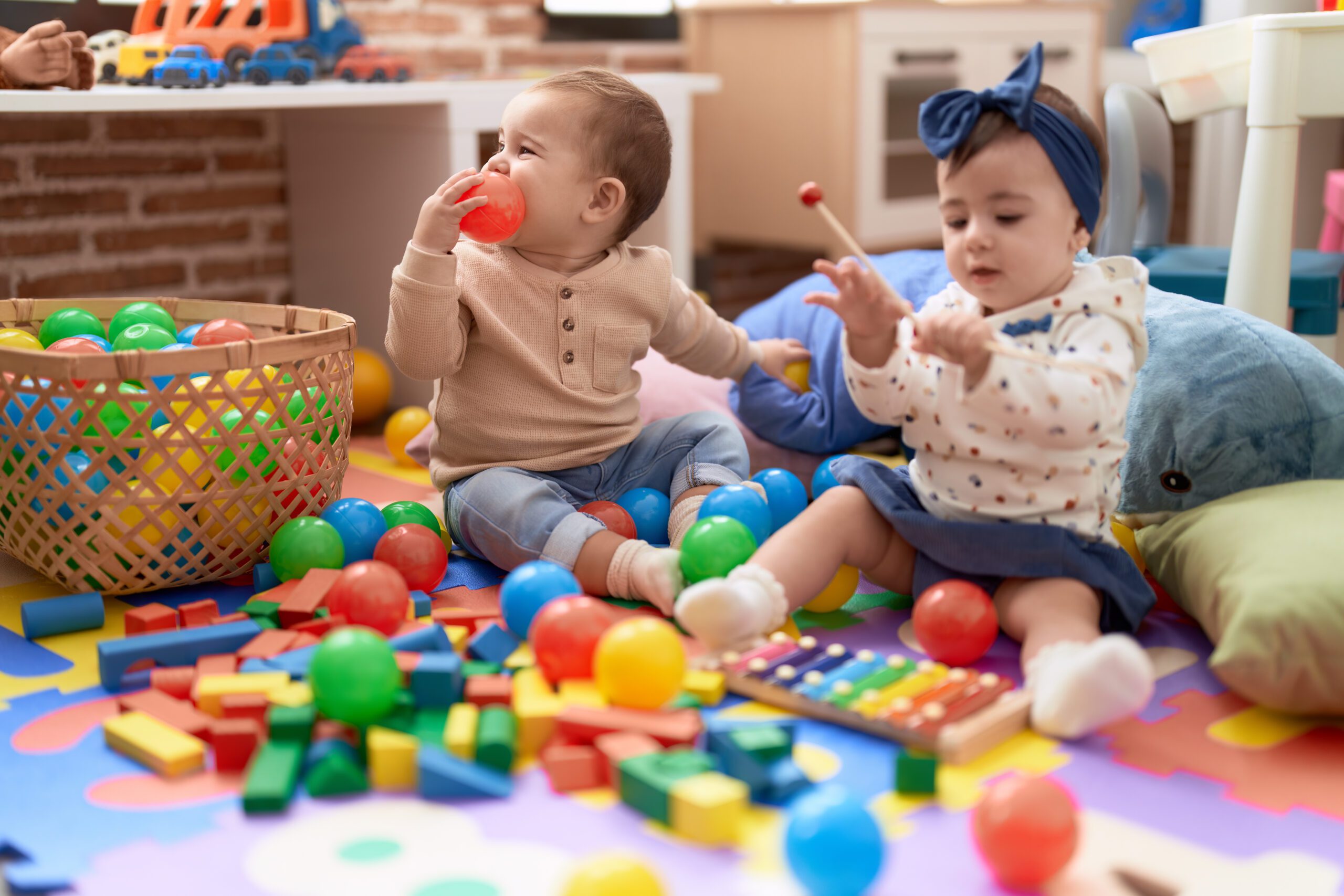 two-toddlers-playing-with-balls-xylophone-sitting-floor-kindergarten